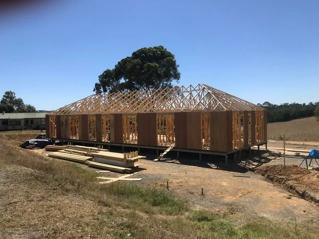 Custom new home build with wall frames and roof trusses installed