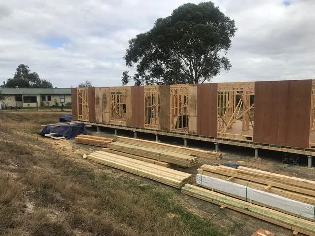 Timber wall frames and structural bracing erected on the subfloor of a custom new home build
