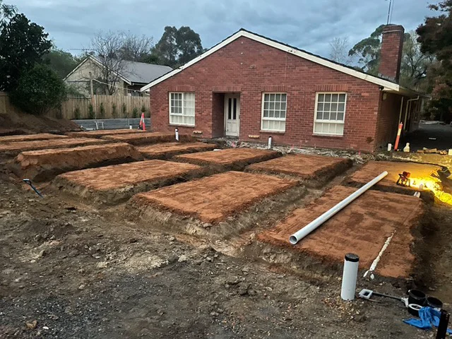 Excavated strip footings for a ground floor extension, ready for the slab pour