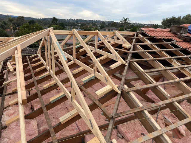 New roof trusses being installed over a second storey extension